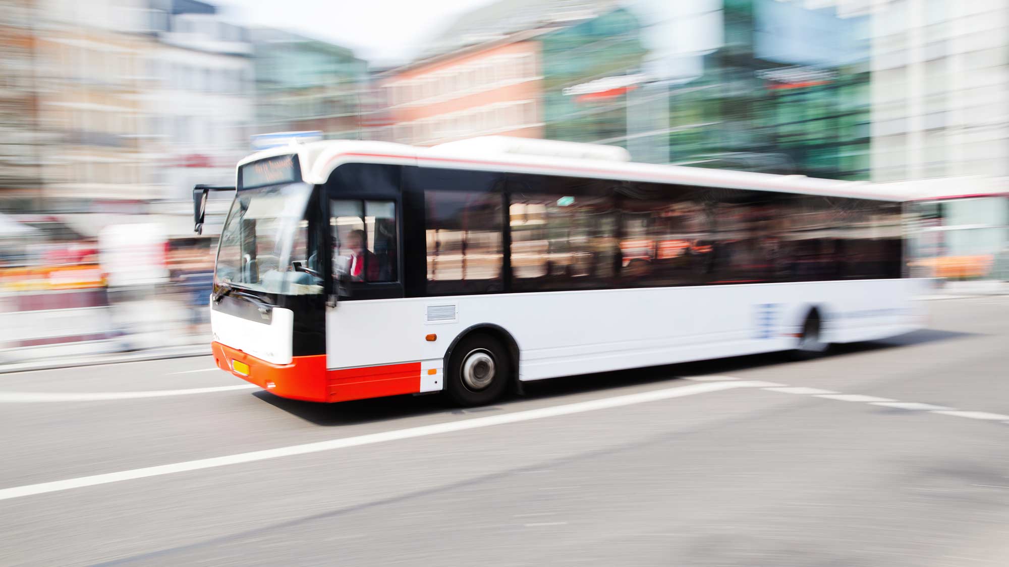 Bus on a city street. Charge4Fleet helps convert bus fleets to all electric