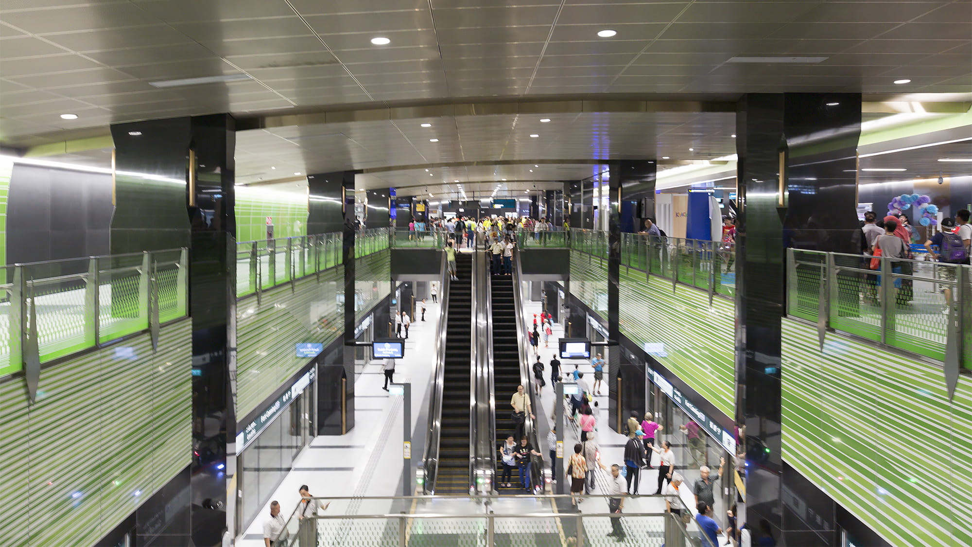 People use escalators inside Fort Canning station