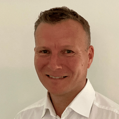 A close up image of a man wearing a white shirt