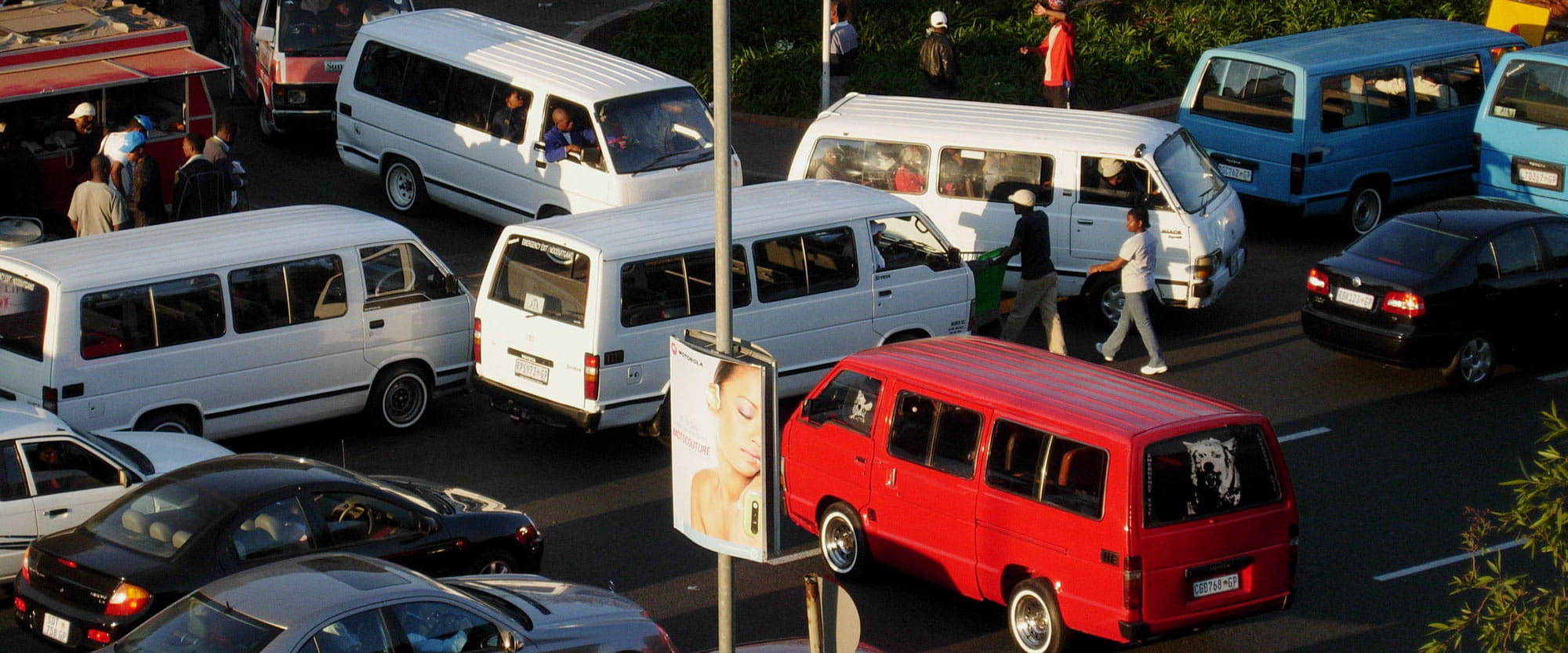 Vans, cars and people congest a road in Johannesburg, South Africa