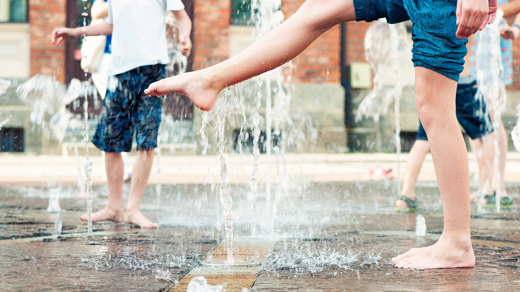 Children playing in a water fountain