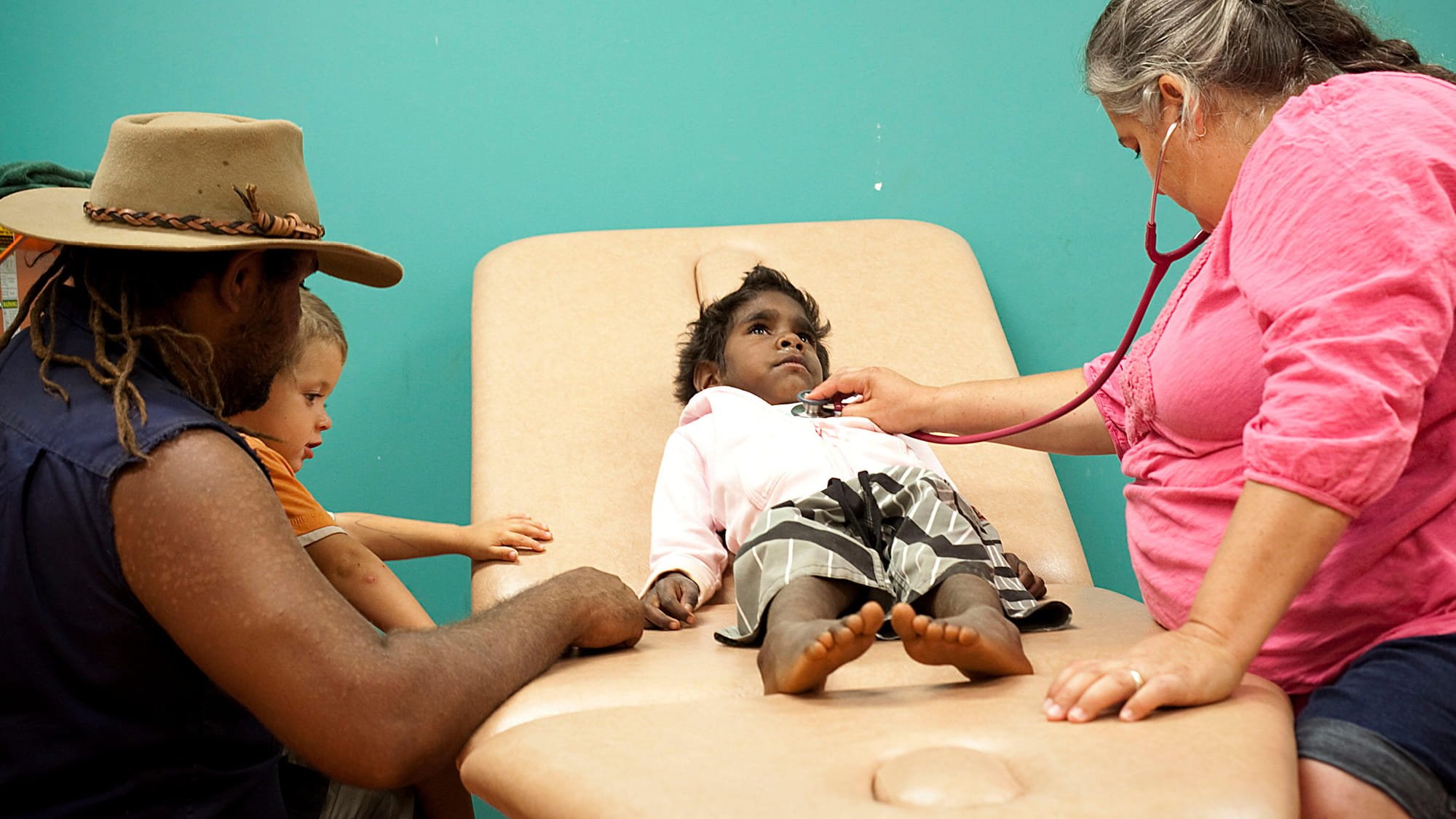 Dr. Christine Jeffries-Stokes, right, conducts a checkup and diabetes screening with Beniah Brooks at a local community health centre in Leonora, Western Australia
