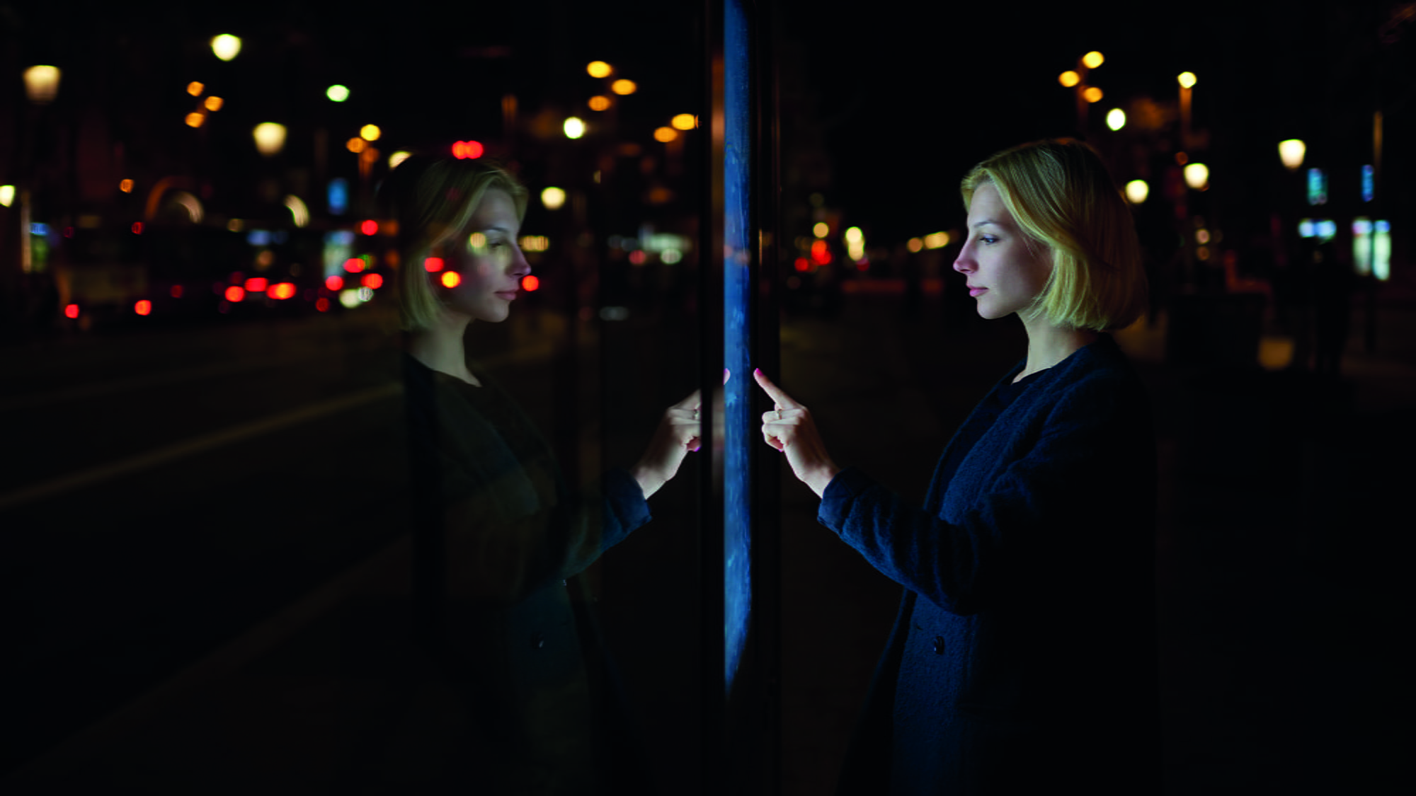 Woman consults on modern big timetable outdoors