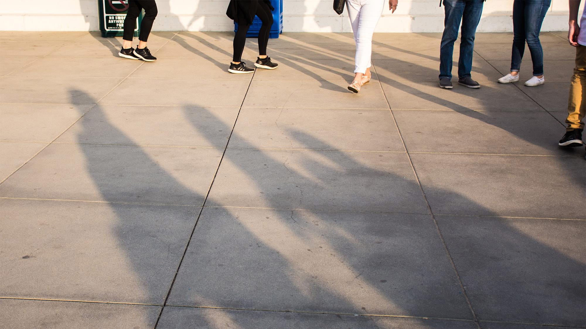 People walking along a city pavement