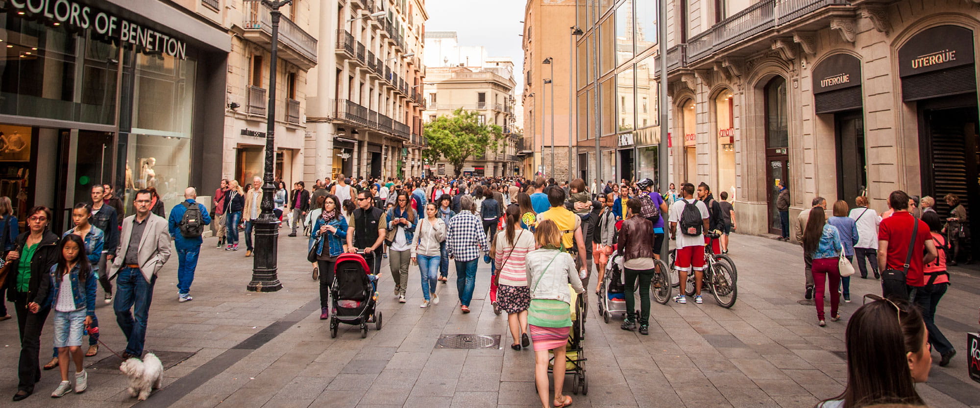 Busy street in Barcelona with people walking and shopping