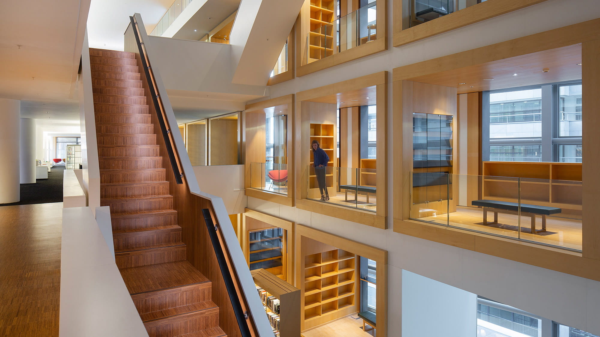 The inside of the library showing individual study rooms and a staircase