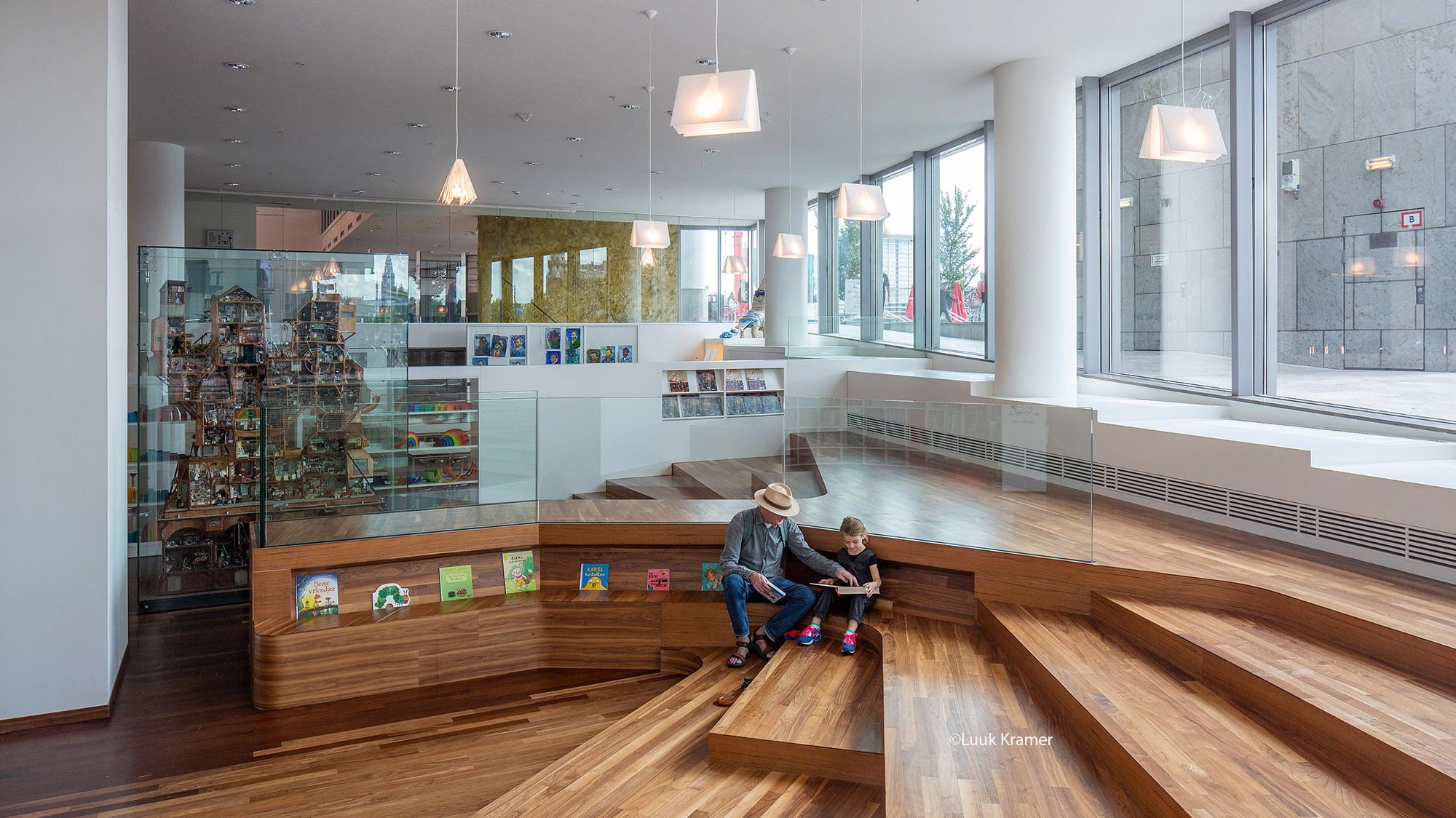 The entrance of the library with large windows and a book shop