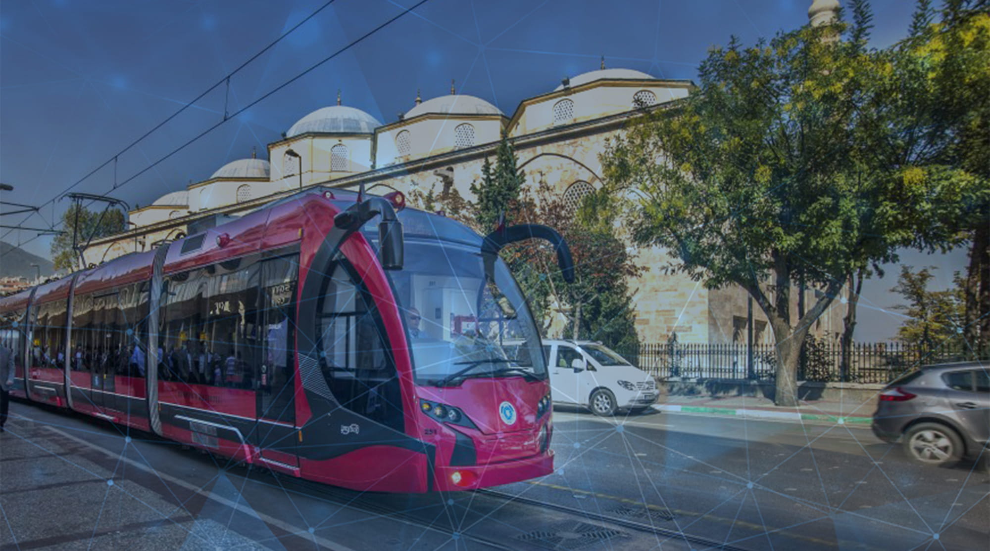A tram passing by in front of a mosque.