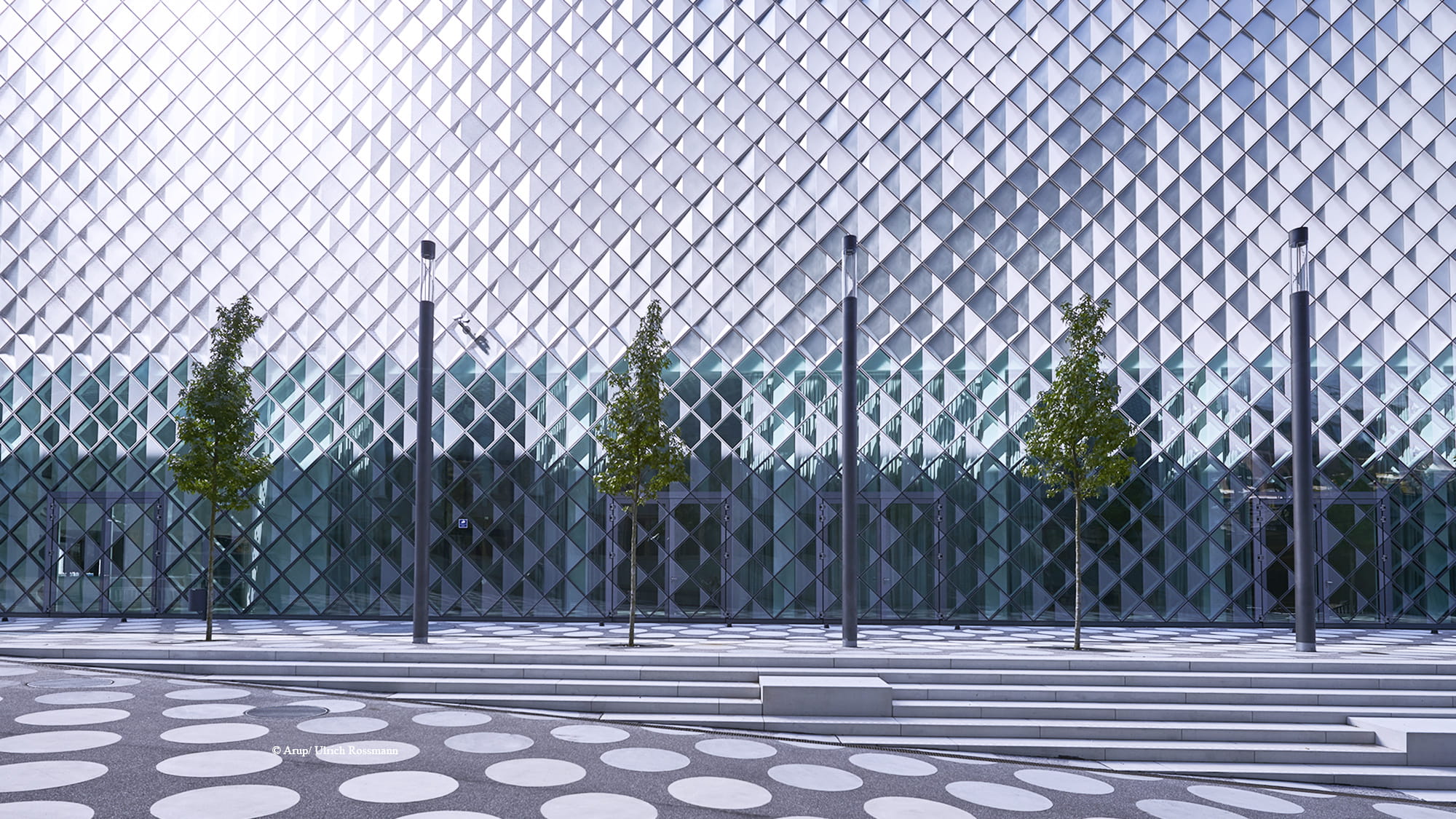 The innovative façade system of the Futurium consisting of prefabricated cassettes combining translucent textured glass on the front with a folded metal reflector on the back.