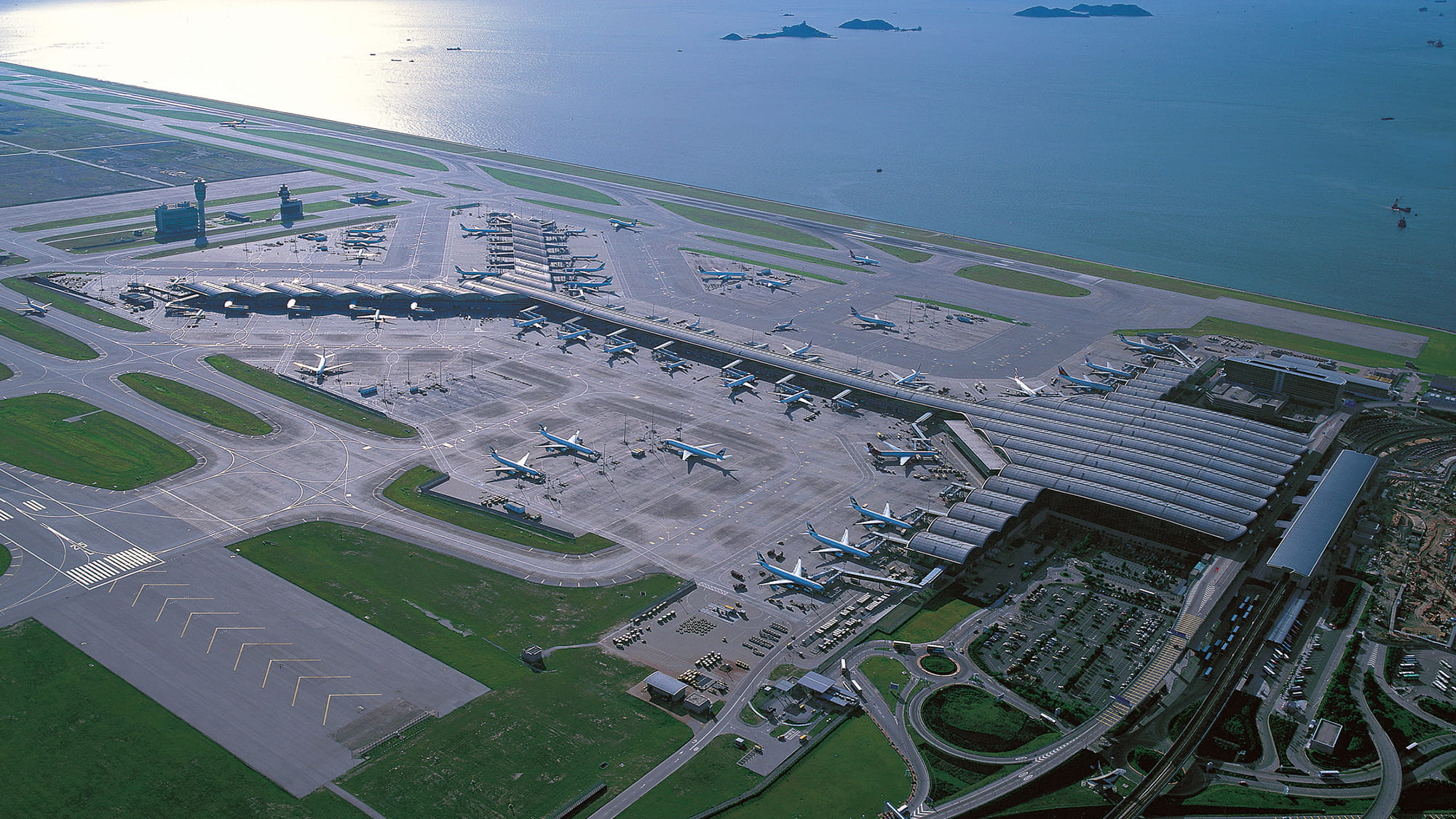 Arial view of Hong Kong International Airport showing the Y-shape of passenger terminal 1  ?Pacific Century Publishers Ltd