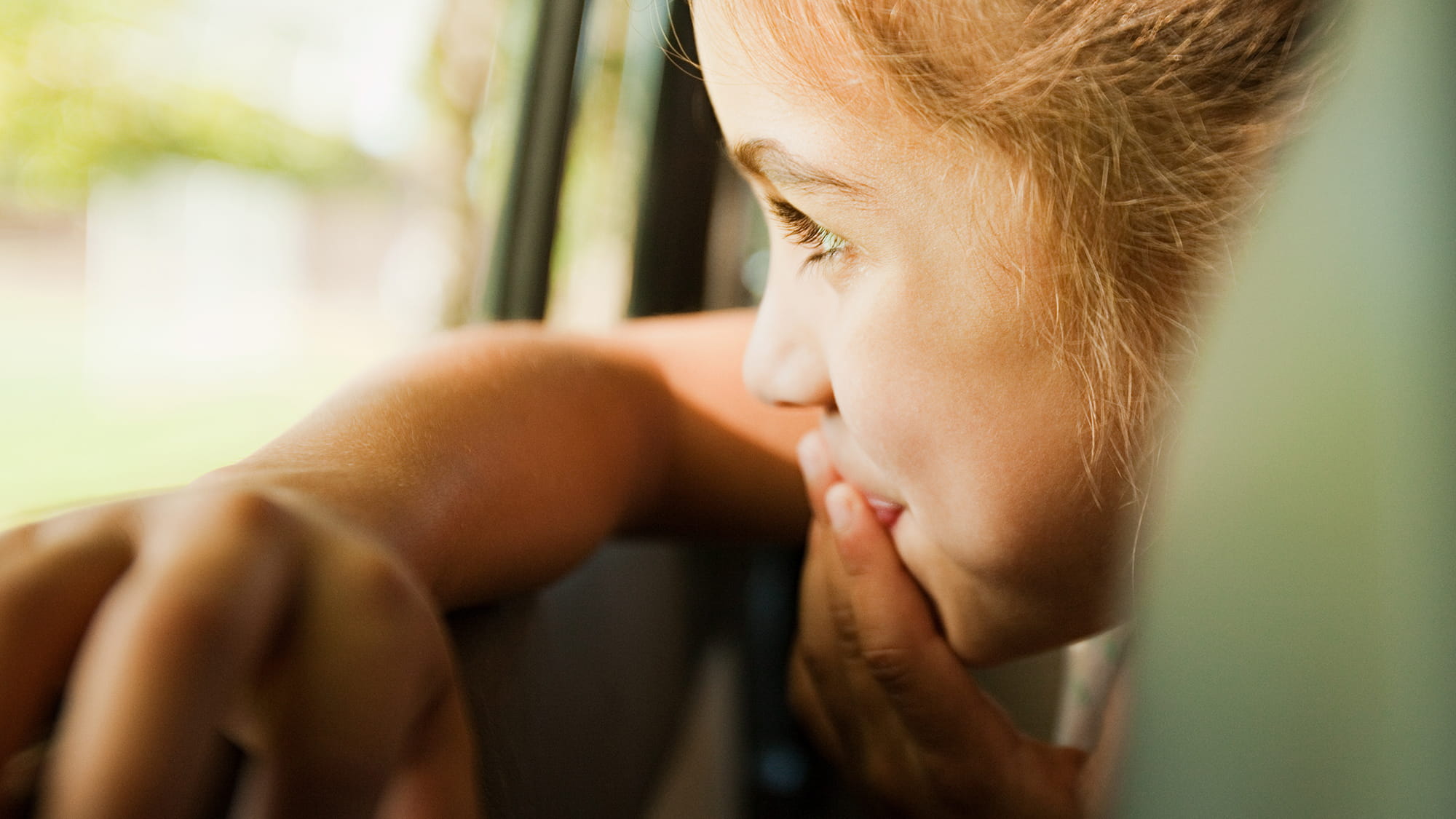 Girl looking out window