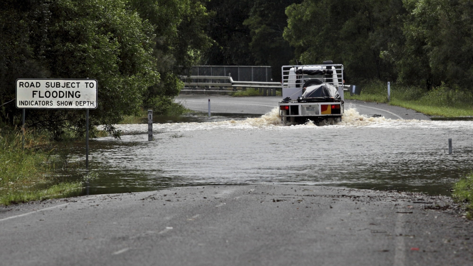A truck driving through flood waters in Queensland