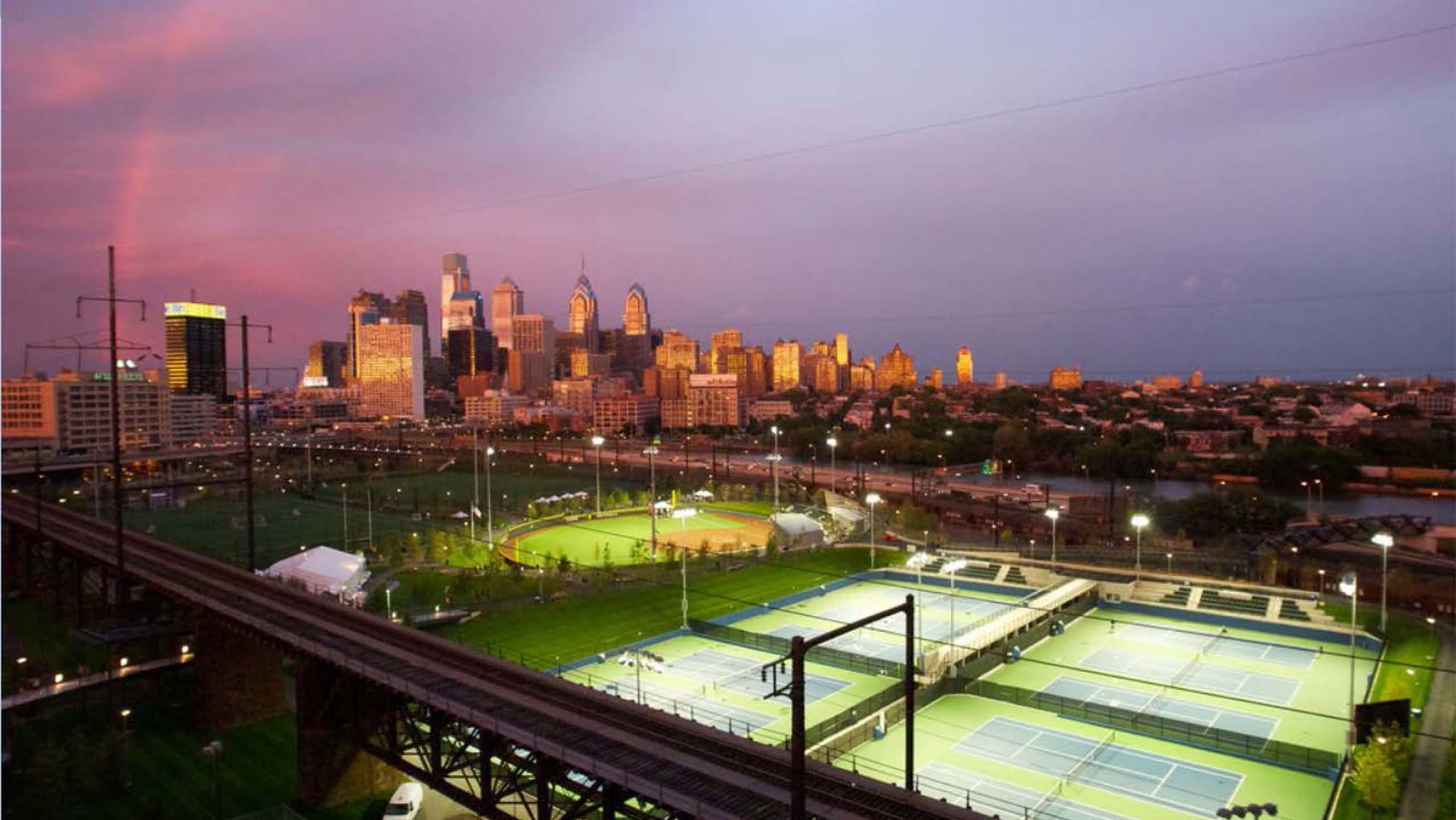 At Penn Park, formal and informal play fields are framed and divided by canopy trees, lawns, and meadows.