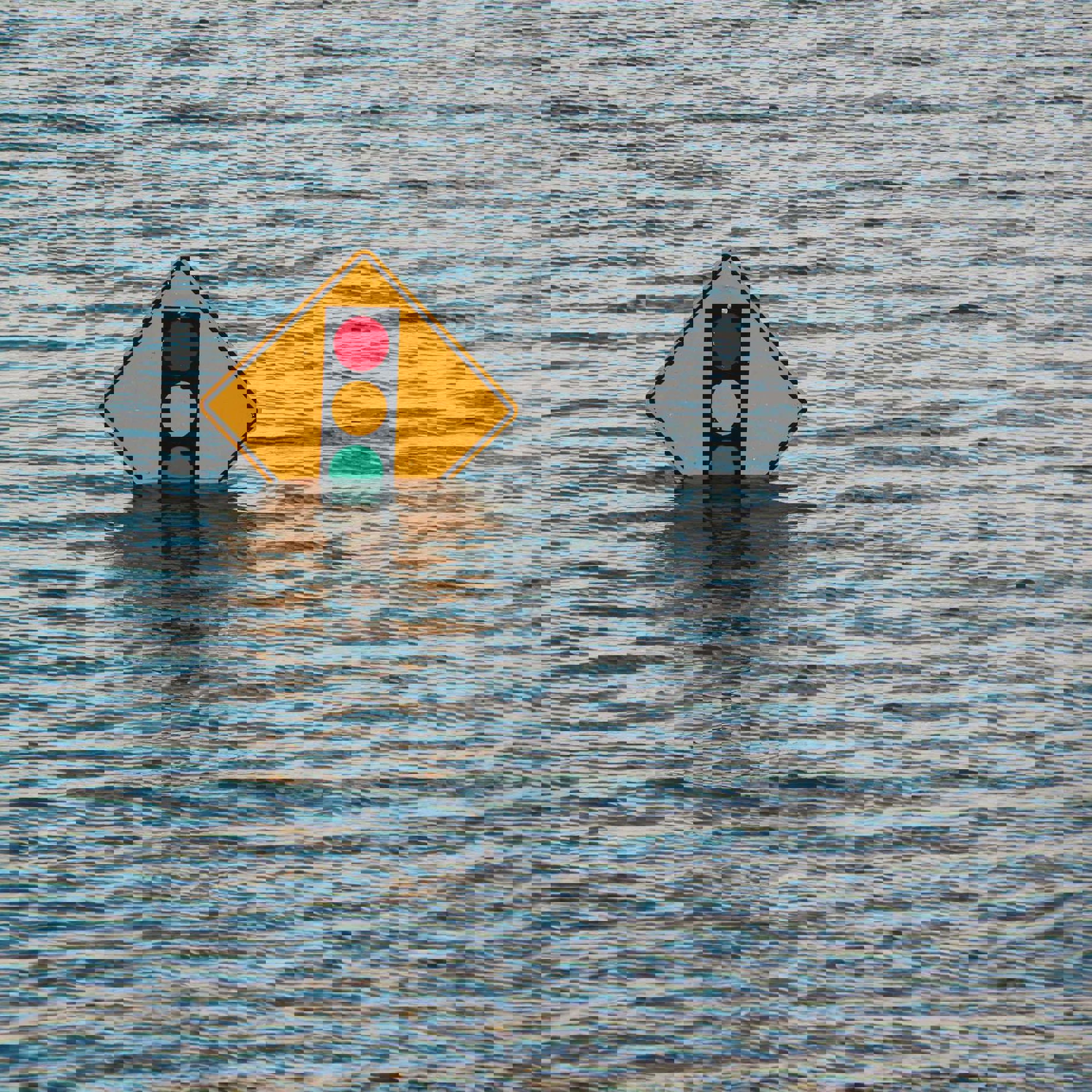 Road sign surrounded by water
