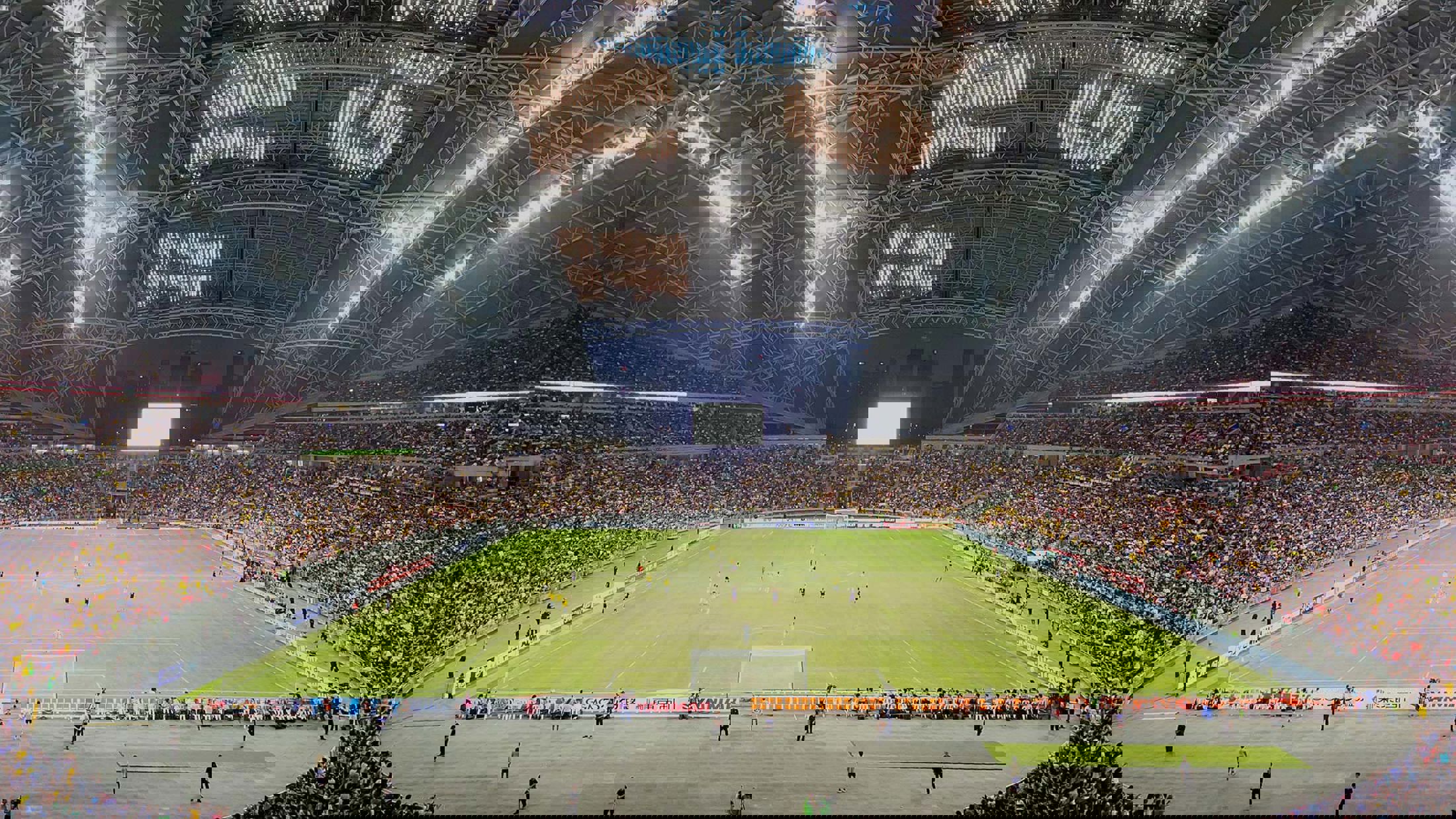 Singapore Stadium hosting football with the roof open