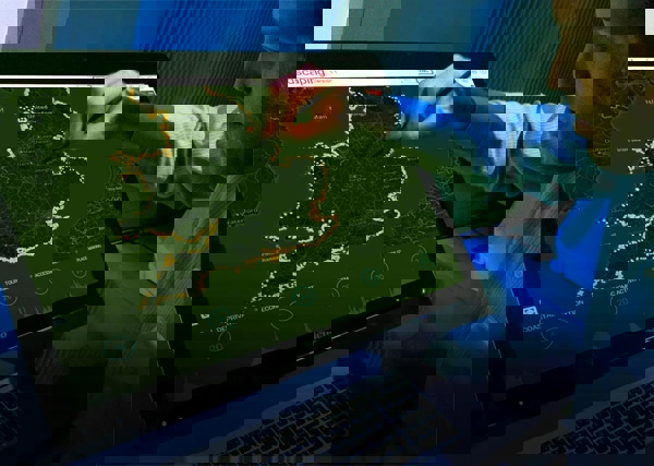Man using a screen to view assets around the UK